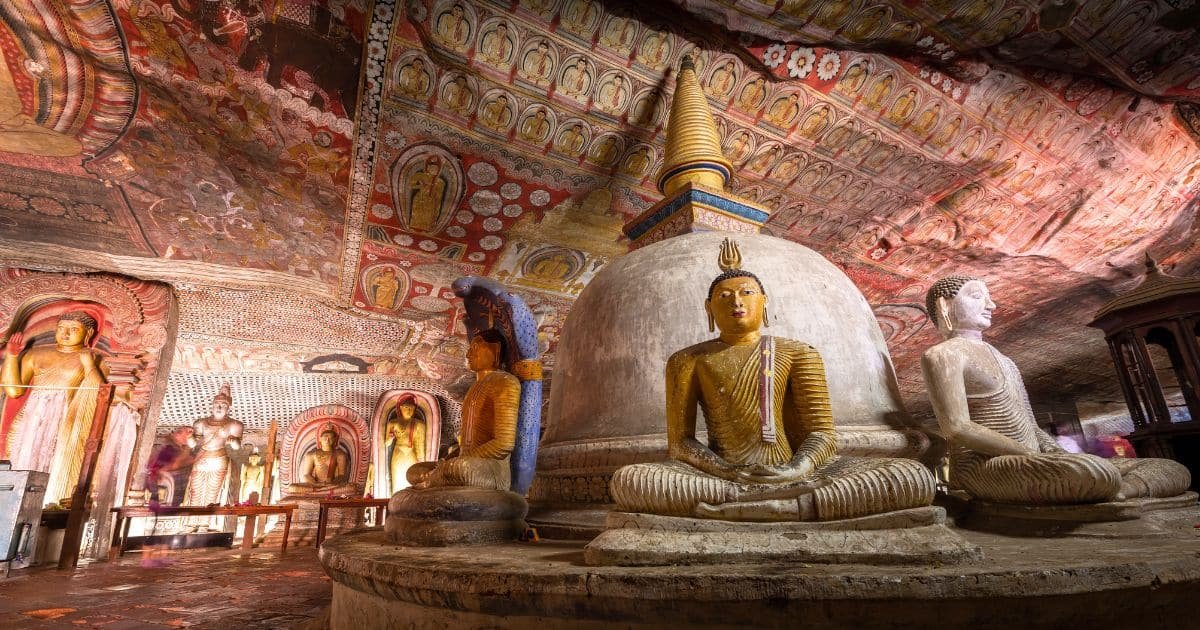 Dambulla Cave Temple interior with Buddha statues and painted ceiling